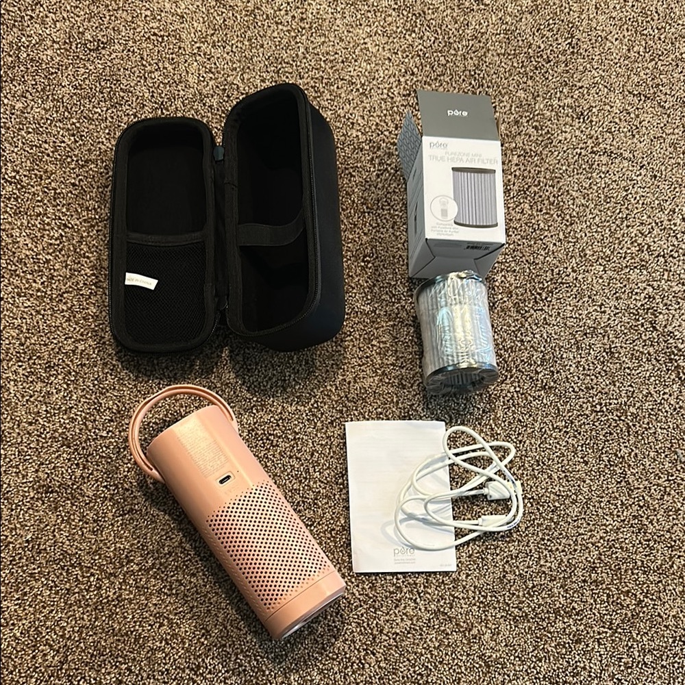Portable pink air purifier, with extra new filter.
